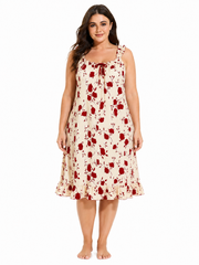 Plus size woman wearing a cream and red floral print nightgown