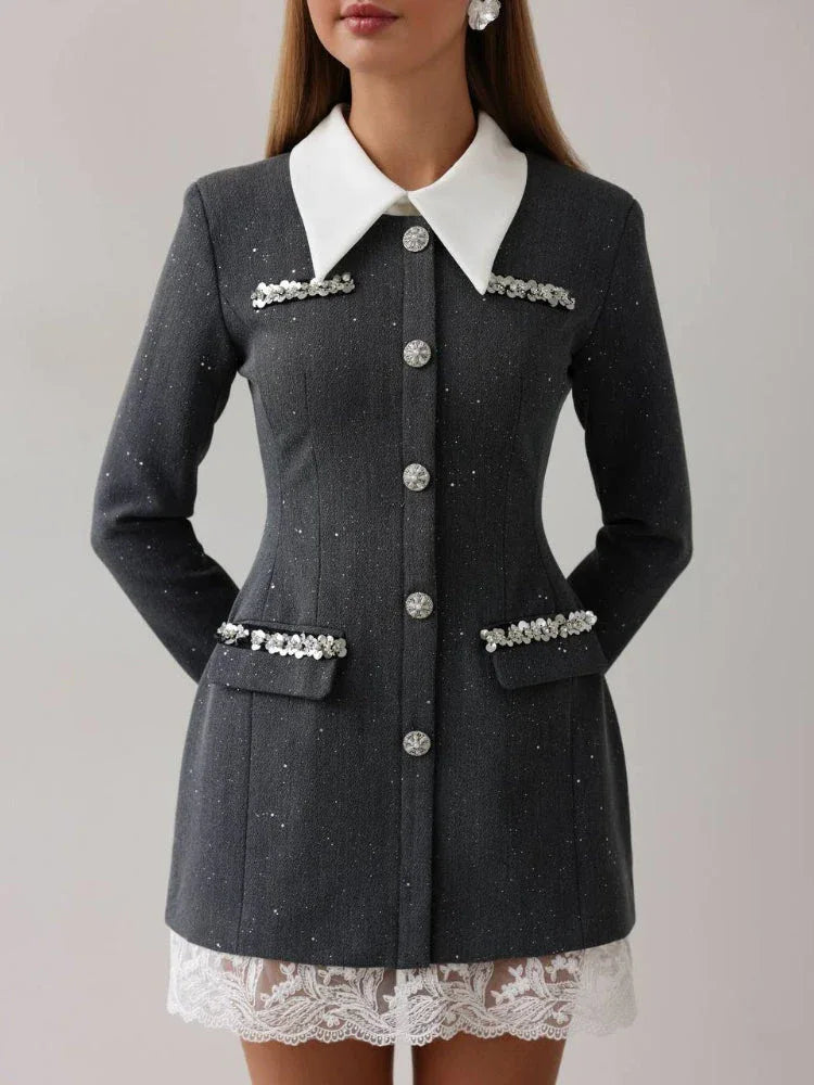 Close-up of the grey tweed mini dress, showing button details and embellishments