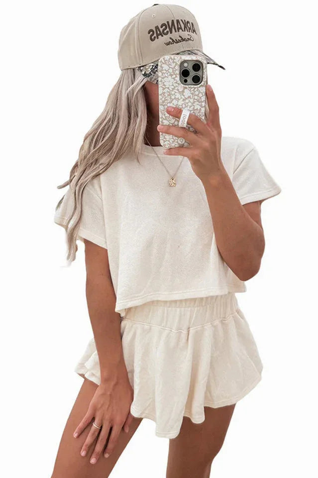 woman wearing an off-white cropped t-shirt and matching shorts set