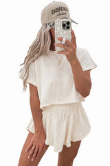 woman wearing an off-white cropped t-shirt and matching shorts set