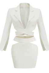 White two-piece set with cut-out details, featuring a wrap top and high-waisted skirt.