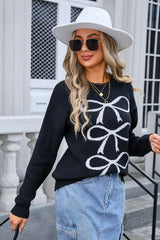 close-up of woman wearing black crew neck sweater with white bow pattern