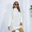 Woman wearing a white knit turtleneck mini dress