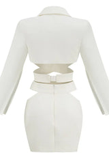 Back view of a white two-piece set with cut-out details and a zipper closure.