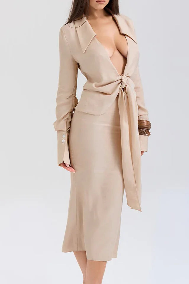 Side view of a woman in a beige linen blend outfit featuring a tie-front top and midi skirt.