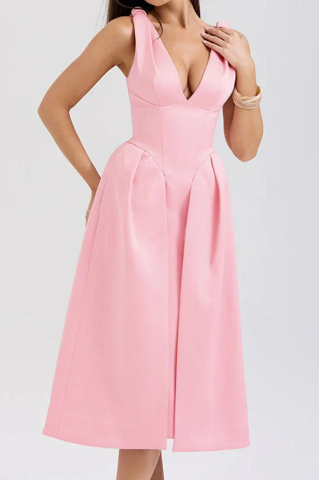Front view of a woman in a pink sleeveless formal dress.