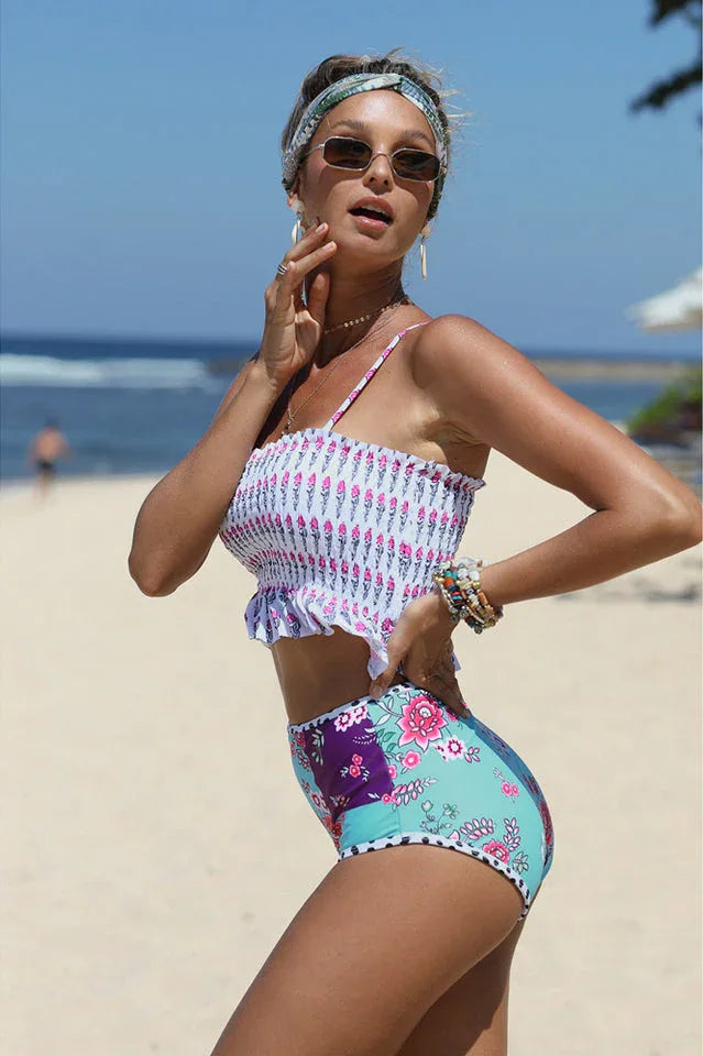 Close-up of a woman in a patterned bikini on a beach