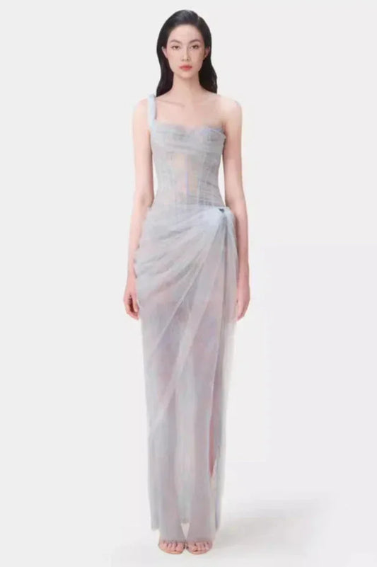Model wearing a light blue sheer tulle gown with a one-shoulder design and corset bodice.
