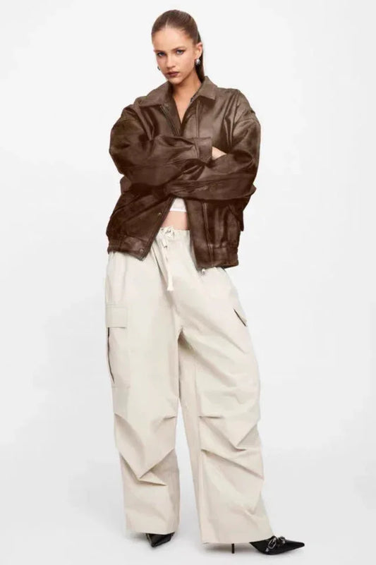 Model wearing a brown faux leather jacket and beige cargo pants