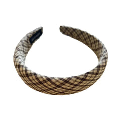 A plaid padded headband on a white background