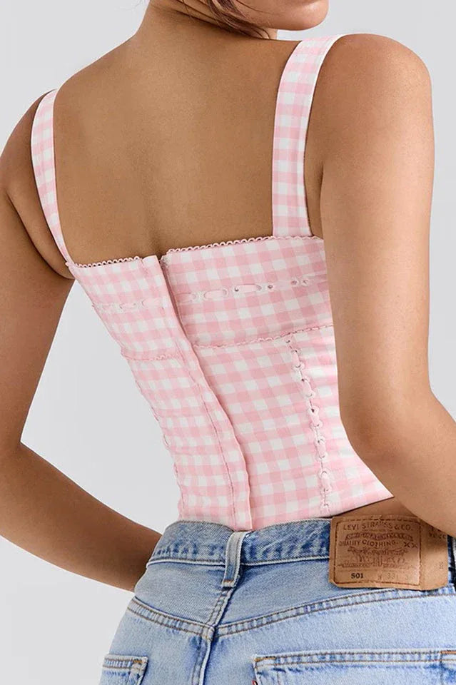 Back view of a pink and white gingham corset top with a zipper closure.