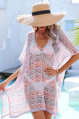 Woman wearing a pastel multi-colored crochet knit kaftan cover-up from the chest up.