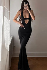 woman in a floor-length black dress with a plunging neckline and cut-out detail
