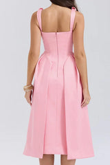 Back view of a woman in a pink formal dress with a zipper closure.