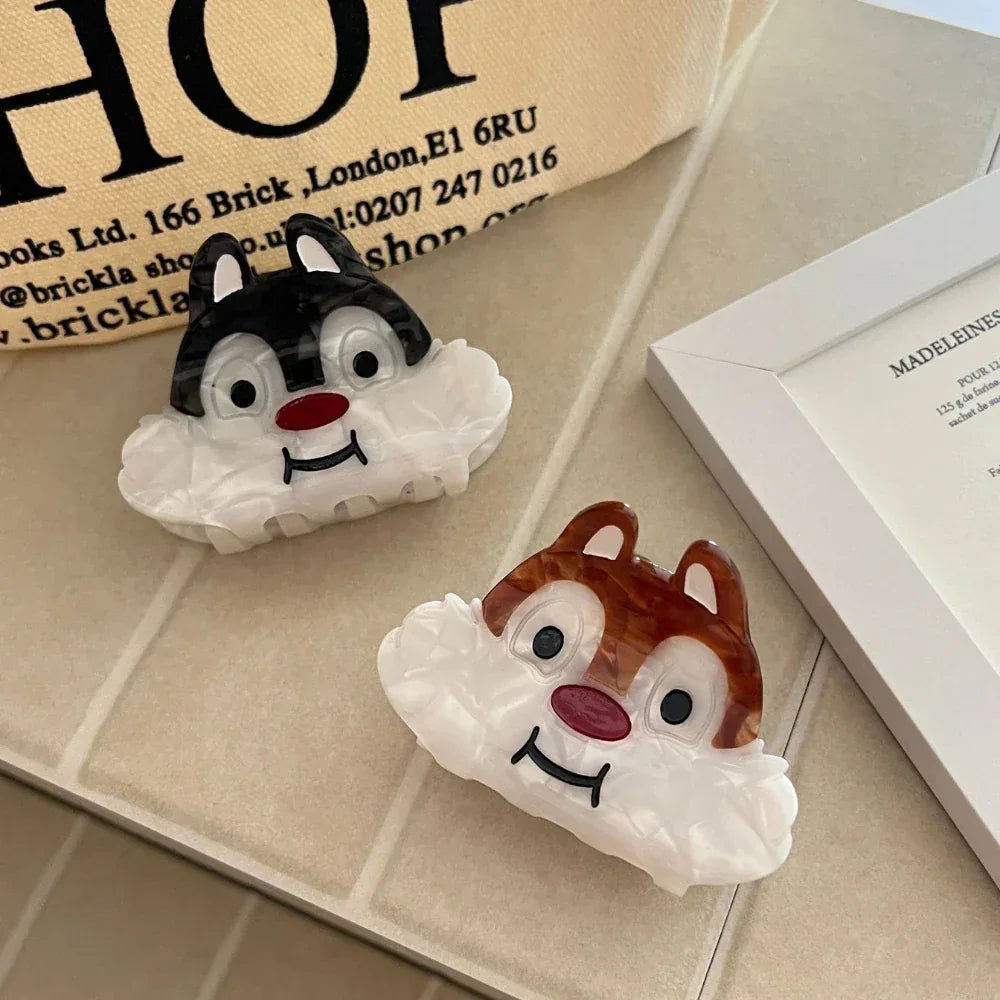 Two cartoon chipmunk face hair claw clips on a tiled surface