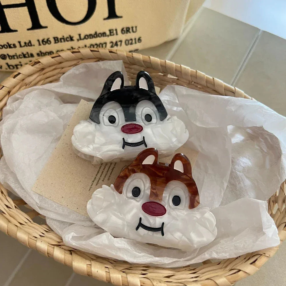 Two cartoon chipmunk face hair claw clips in a woven basket