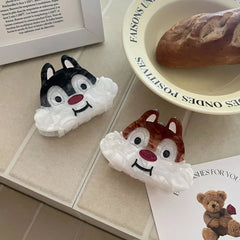 Two cartoon chipmunk face hair claw clips on a tiled surface with a bread bowl