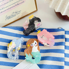 mermaid hair clips on striped fabric