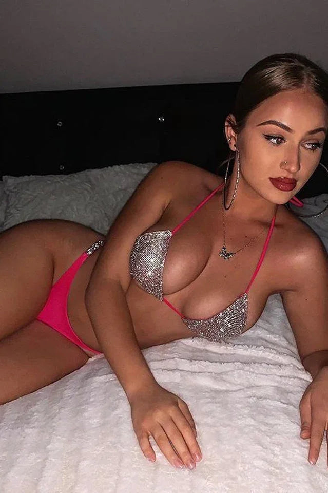 Woman lying down wearing a sparkly pink bikini