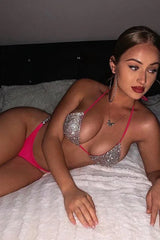 Woman lying down wearing a sparkly pink bikini