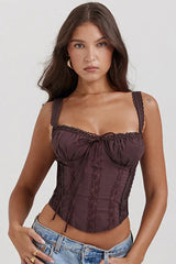 Model wearing a brown satin corset top with lace trim and tie front