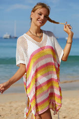 Woman with braided hair wearing a striped crochet knit kaftan on the beach