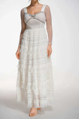 Front view of a white tiered tulle gown with a sweetheart neckline and bow detail