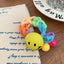 Braided terry cloth hair tie with a yellow smiley face charm - View 6 | TEVQA
