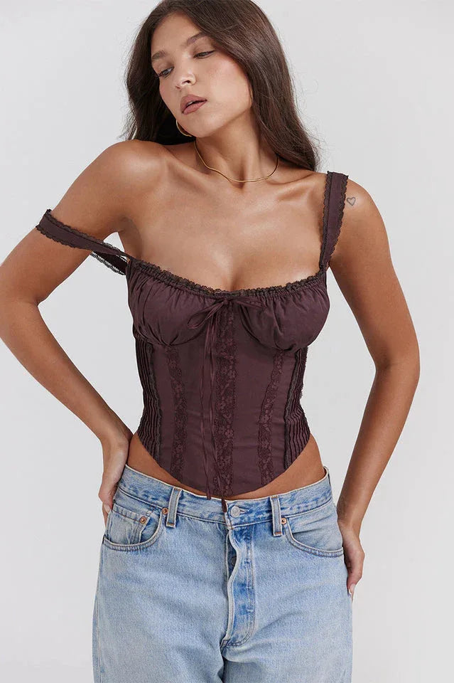 Model showing the side of a brown satin corset top with lace trim