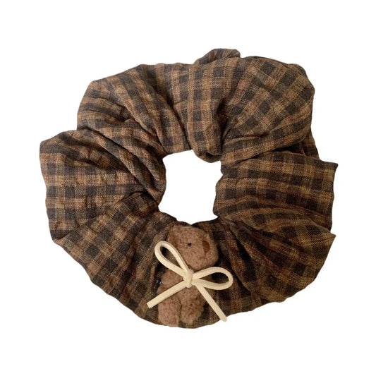 brown and black plaid scrunchie with a small teddy bear and white bow