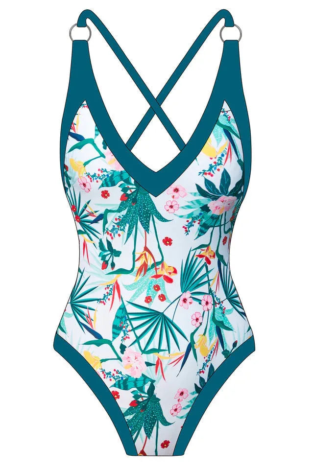 Flat lay of a white one-piece swimsuit with a tropical floral print and teal trim.