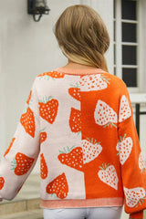 Back view of a woman wearing a strawberry print knit cardigan with colorblock design.
