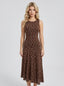 Woman wearing a brown polka dot midi dress, front view