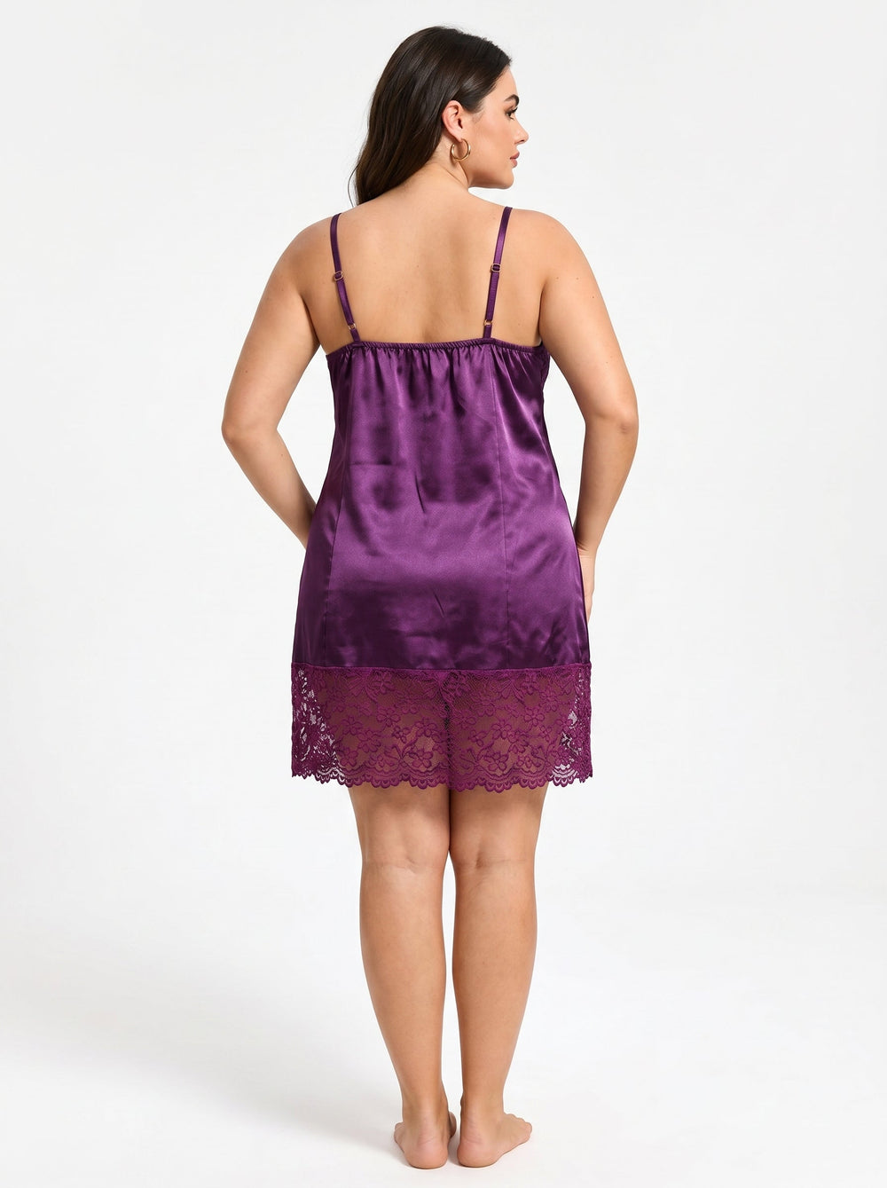 Back view of a woman in a purple satin chemise with lace hem