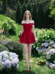 Woman in a red off-the-shoulder mini dress walking through a garden with hydrangeas
