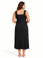 Back view of a woman in a black ribbed knit nightgown