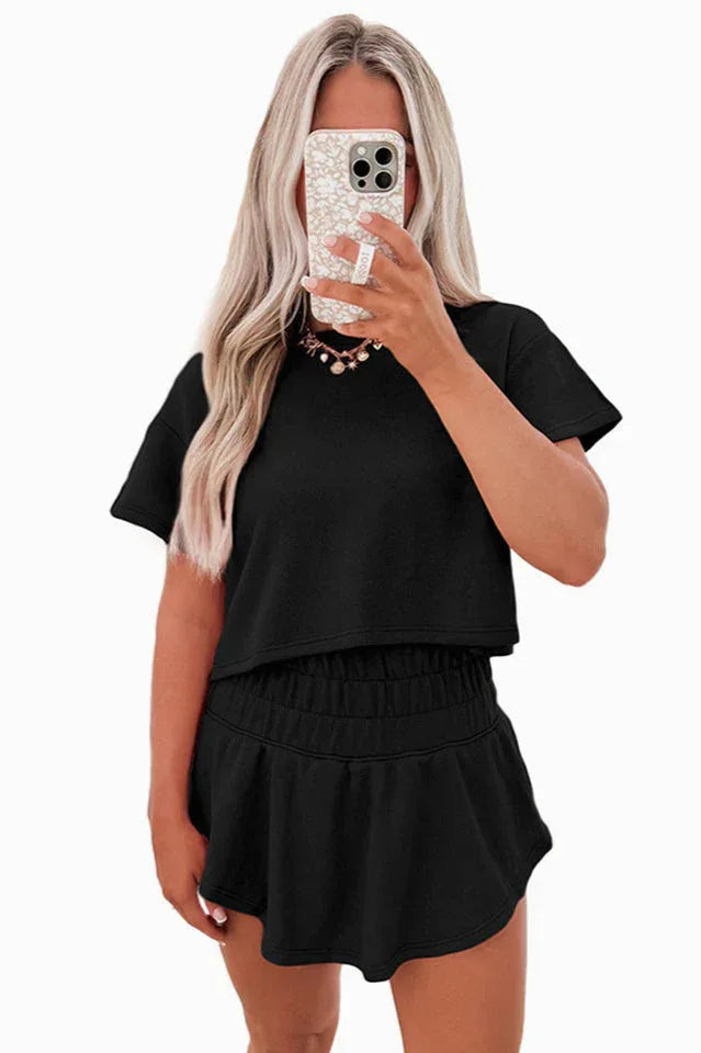 woman wearing a black cropped t-shirt and matching shorts set