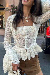 Close-up of a white lace peplum top with square neckline and ruffled trim.