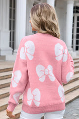 back view of a woman wearing a pink sweater with white bow prints