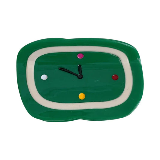 Green clock-shaped hair clip with colorful dots
