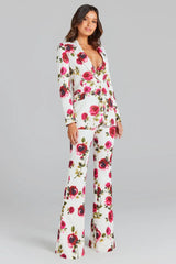 Full body shot of a woman in a white floral print suit