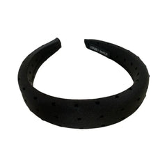 A black puffy headband with a scattered heart print.