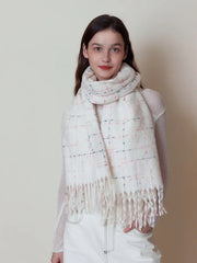 Woman wearing a white plaid scarf with pink and grey accents