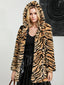 Woman wearing a hooded faux fur tiger print long coat.