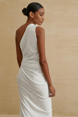 Back view of a model in a white one-shoulder draped dress