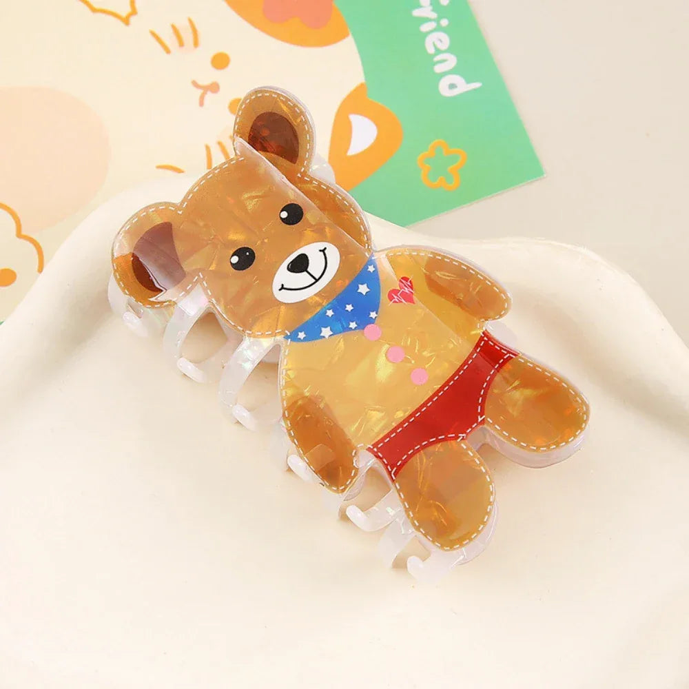 Brown iridescent bear-shaped hair claw clip with a detailed outfit