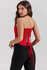 Back view of a red strapless corset with intricate red lace-up detailing.