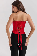 Rear view of a red strapless corset, highlighting the adjustable lace-up closure.