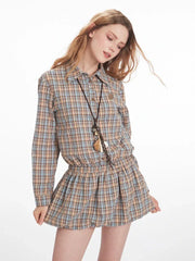 Model posing in a plaid shirt dress