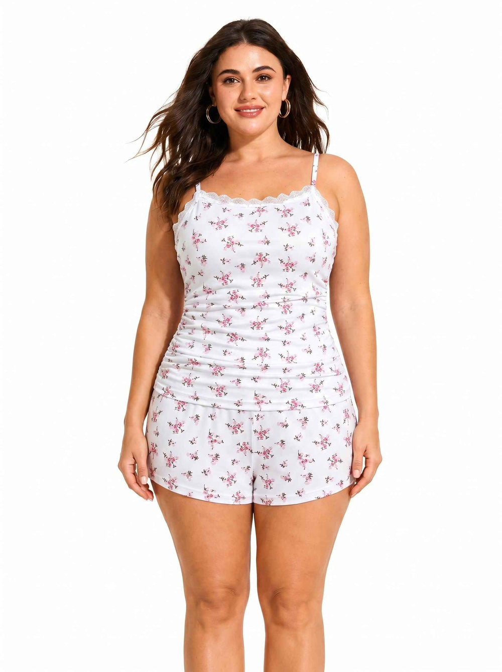 Woman posing in white floral print pajama camisole and shorts